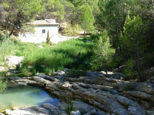 Caseta del sondeo artesiano del camping de La Puerta. En primer plano las calizas del Eoceno casi verticales 